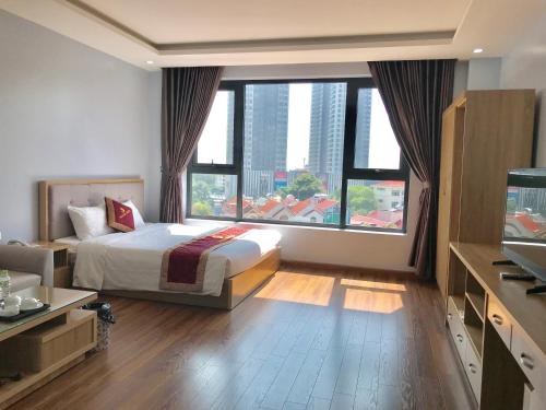 a hotel room with a bed and a large window at Phoenix3 Hotel Bắc ninh in Bắc Ninh