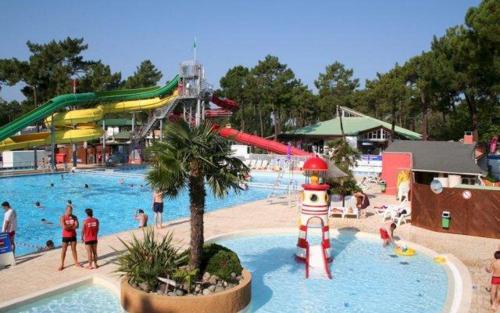 a pool with a water park with people in it at CAMPING BONNE ANSE PLAGE in La Palmyre