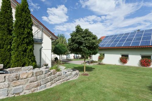 a house with solar panels on the roof at Engelhard Das Landhotel Garni in Kirchheim am Ries