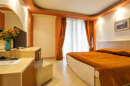 Ένα ή περισσότερα κρεβάτια σε δωμάτιο στο Family Hotel Gold Pearl