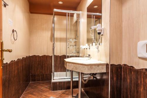 a bathroom with a sink and a shower at Family Hotel Gold Pearl in Sunny Beach