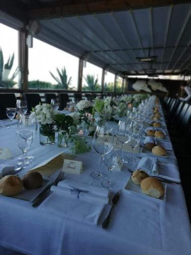 a long table with plates and wine glasses on it at Rouge Hotel International in Milano Marittima