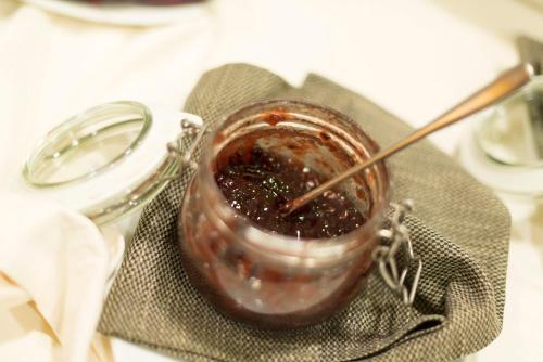 a jar of sauce with a spoon in it on a table at Hotel Colle Del Sole in Alberobello