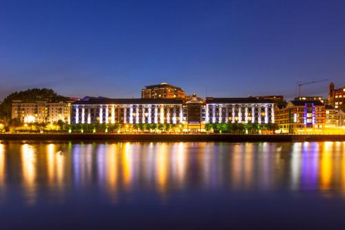 a city lit up at night next to a body of water at Copthorne Hotel Newcastle in Newcastle upon Tyne