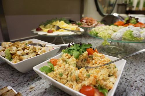 a table with several plates of food on it at Hotel Mistral in Marki