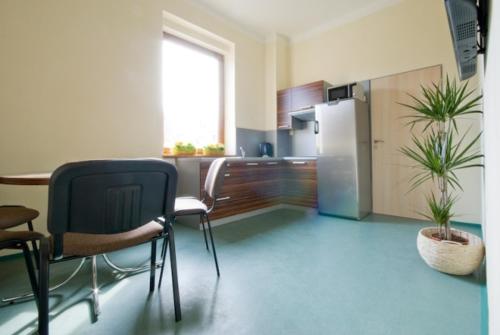 a kitchen with a table and chairs and a refrigerator at Penzion Svet in Třinec