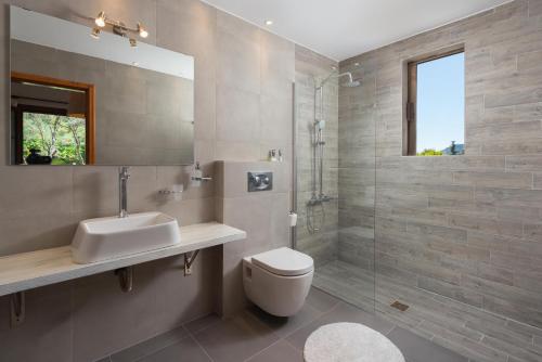 a bathroom with a toilet and a sink and a shower at Una Villa Rhodes in Ixia