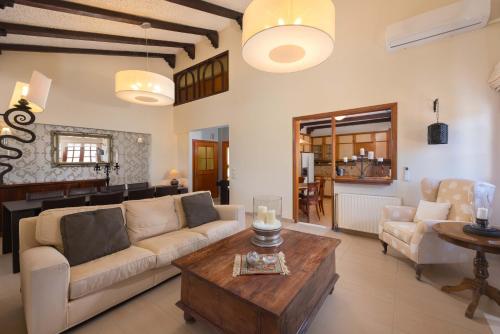 a living room with a couch and a table at Una Villa Rhodes in Ixia