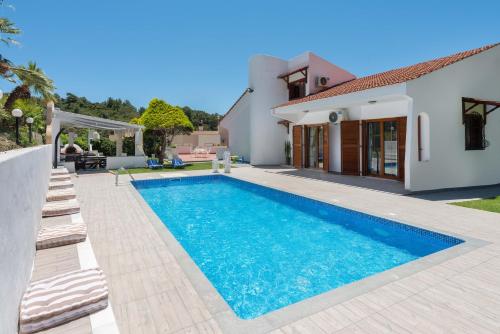 a swimming pool in the backyard of a house at Una Villa Rhodes in Ixia