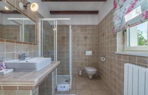 a bathroom with a sink and a toilet at Villa Sana in Selina