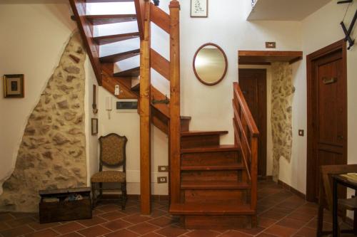 a wooden staircase in a room with a mirror at La Rupe Bed and Breakfast in Norma