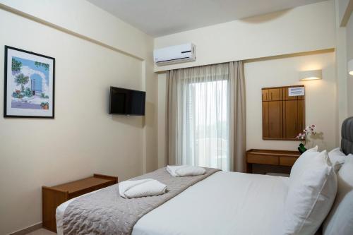 a hotel room with a bed and a window at Gramvoussa Bay in Kissamos
