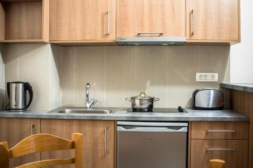 a small kitchen with a sink and a stove at Gramvoussa Bay in Kissamos