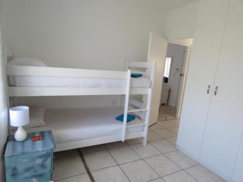 a room with two bunk beds in a room at Sea Jewel in Pearly Beach