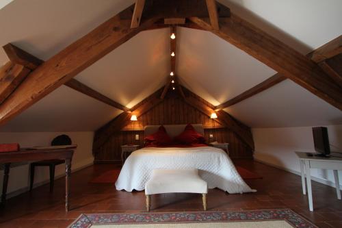 a bedroom with a bed in a attic at Le Clos Xavianne in Ribécourt-la-Tour