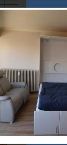 a living room with a couch and a bed at Studio Mare Nostrum in Blankenberge