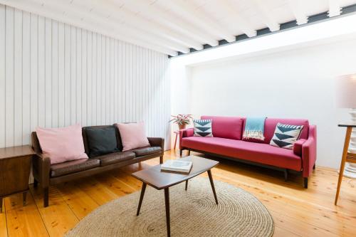a living room filled with furniture and a couch at Patio São Vicente in Lisbon