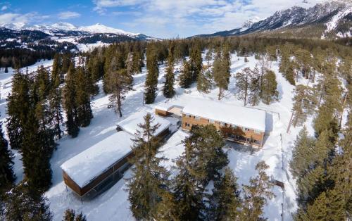 an aerial view of a building in the snow at Sport- und Ferienhaus Don Bosco in Lenzerheide