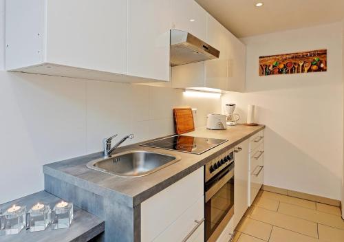 a kitchen with a sink and a counter top at Design Apartment nähe Düsseldorf in Krefeld