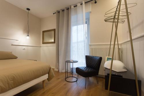 1 dormitorio con 1 cama, 1 silla y 1 ventana en Casa degli Orefici, en Campobasso