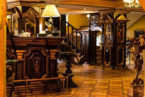 a room with a bar with a table and chairs at Ambassador Hotel in Timişoara