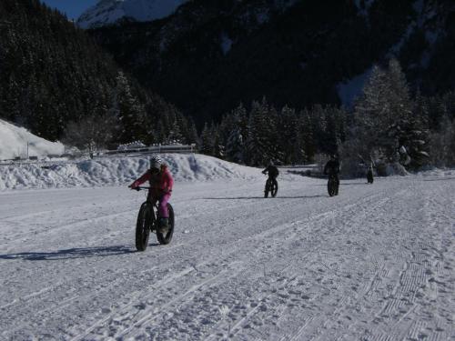 a group of people riding bikes in the snow at Albergo Thurwieser in Santa Caterina Valfurva