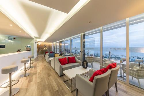 a hotel lobby with a view of the ocean at Meliá Maputo Sky in Maputo