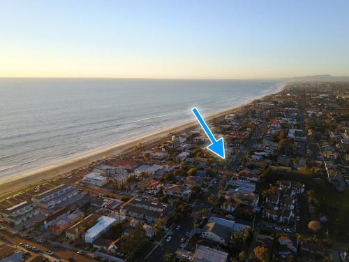 an aerial view of a beach with a blue arrow at Ultimate Beach Bungalow - 1 block from beach - huge backyard in Carlsbad