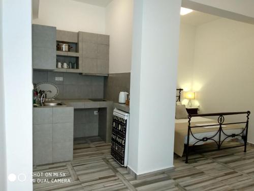 a kitchen with a sink and a stove top oven at Waterside Apartments in Ayia Evfimia