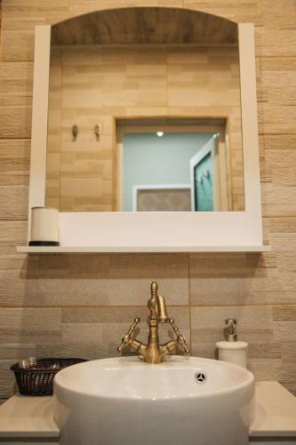 a bathroom with a sink and a mirror at Апартамент Барок in Lovech