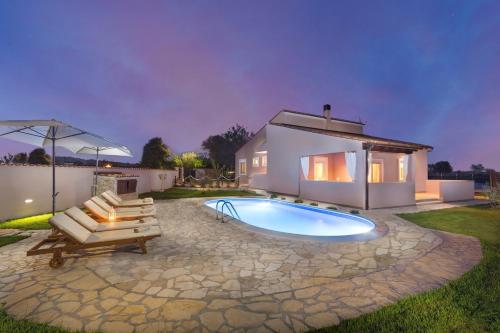 a swimming pool in the backyard of a house at Villa Agri with large Garden and Pool near Pula in Loborika