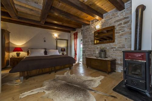 a bedroom with a bed and a wood stove at Casa Katarina&Luka in Višnjan