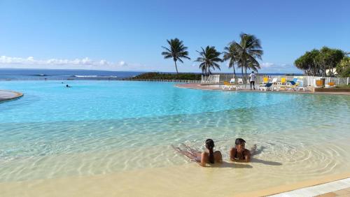 two women laying in the water in a swimming pool at So Chic in Saint-François