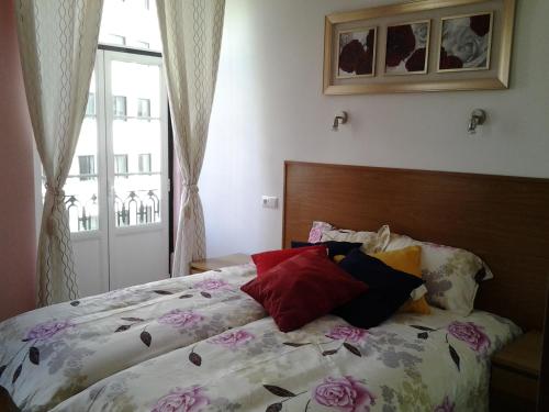a bedroom with a bed with flowers on it at Baixa GuestHouse in Lisbon