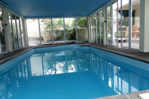 a swimming pool in a house with a large window at Sacha Tourist Residence 2 in Mahébourg