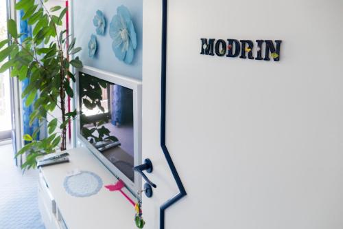 a door that says momma next to a plant at Modrin Apartments in Kamnik