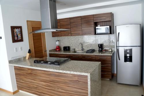 a kitchen with a refrigerator and a counter top at Metropolitan Suites in Guadalajara