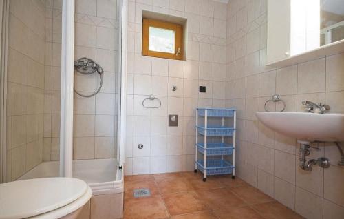 a bathroom with a toilet and a sink and a tub at Holiday House Klarin with Sea View in Preko