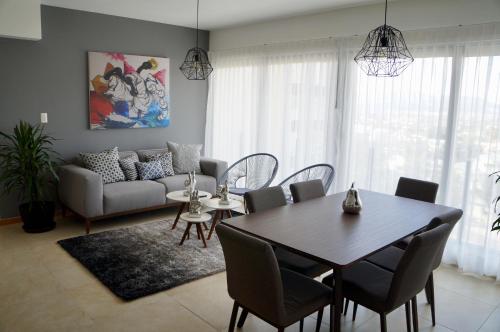 a living room with a table and a couch at Metropolitan Suites in Guadalajara