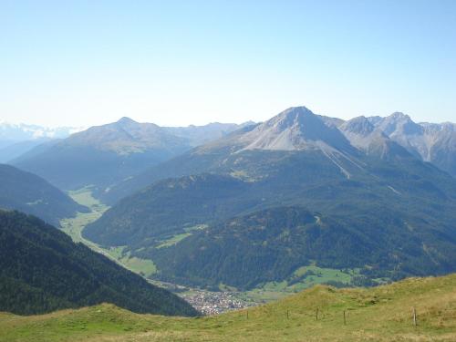 a view of a mountain range with a town in a valley at Apart Claudia in Nauders