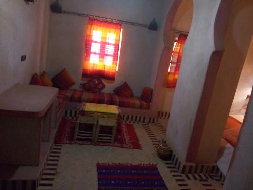 a living room with a couch and a table at Camels House in Merzouga