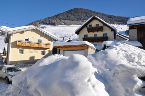 a pile of snow in front of a house at Apart Claudia in Nauders