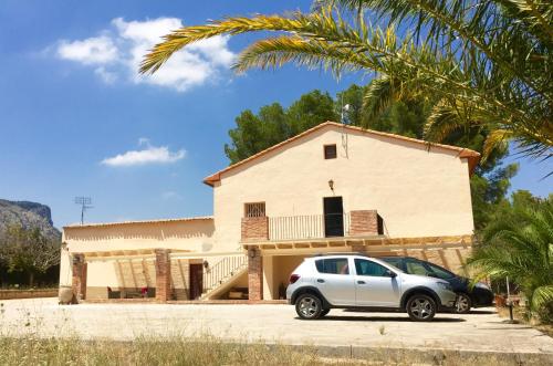 a white car parked in front of a house at Casa de Los Lirios in Muro de Alcoy