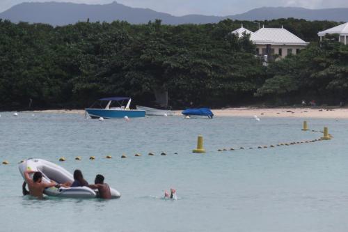 a group of people in the water at a beach at Sacha Tourist Residence 2 in Mahébourg