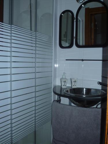 a bathroom with a sink and a mirror at CaLi casa Rural in Lugo