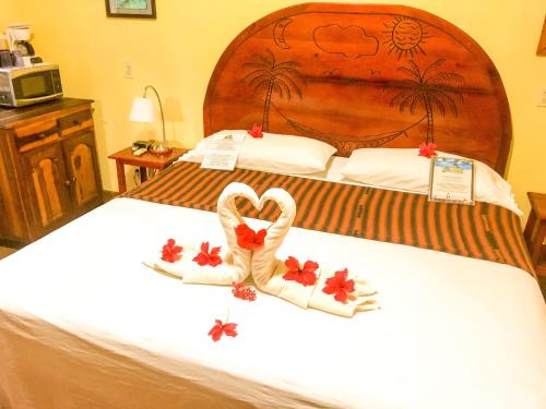 two swans made out of towels on a bed at Bananarama Dive & Beach Resort in West Bay