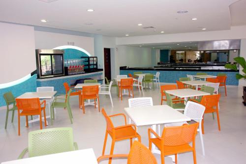 an empty dining room with tables and chairs at Azul Ixtapa Grand All Inclusive Suites - Spa & Convention Center in Ixtapa