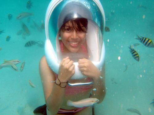 a young girl is under the water in the aquarium at Surfside Boracay Resort in Boracay