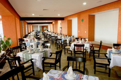 a row of tables and chairs in a restaurant at Azul Ixtapa Grand All Inclusive Suites - Spa & Convention Center in Ixtapa