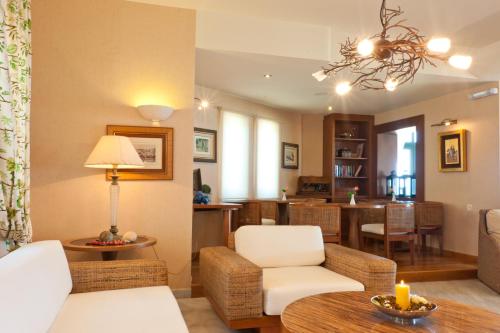 a living room with a couch and a table at Silver Beach Hotel & Apartments in Gerani Chanion